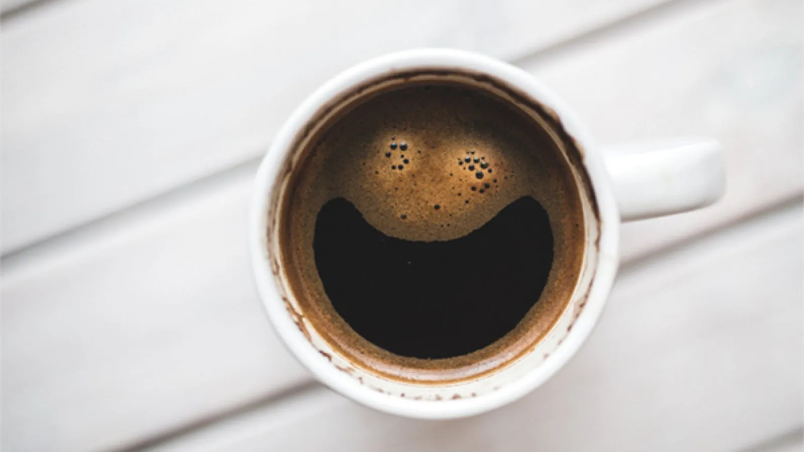 White mug with dark coffee in it