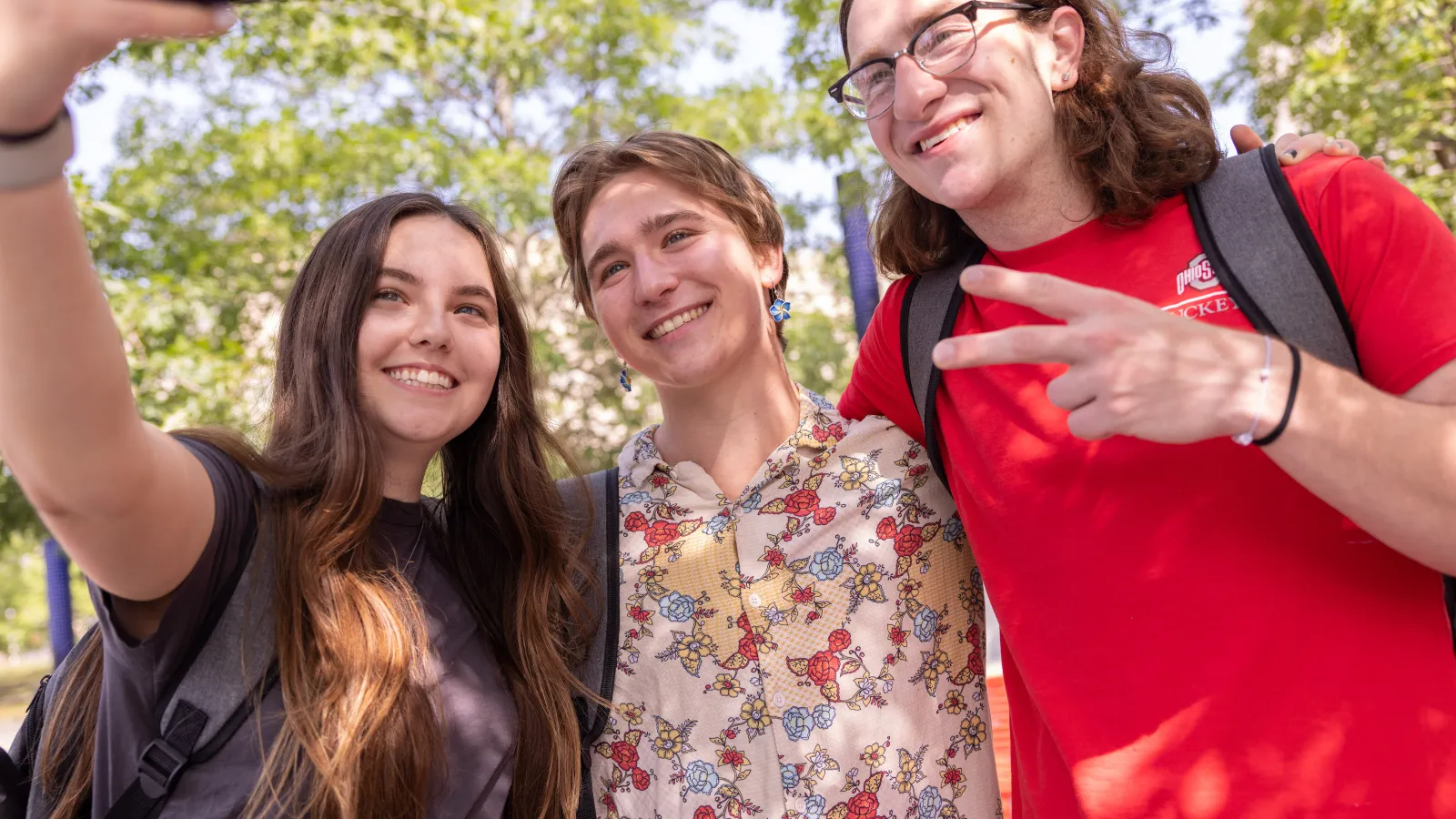 three young people posing for a selfie