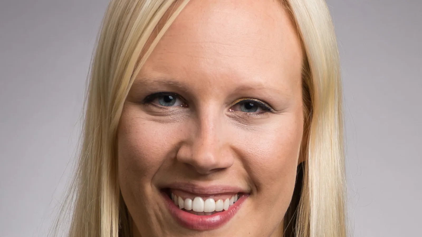 Professor Hollie Nyseth Brehm, white female smiling at camera wearing black blazer, long blond hair