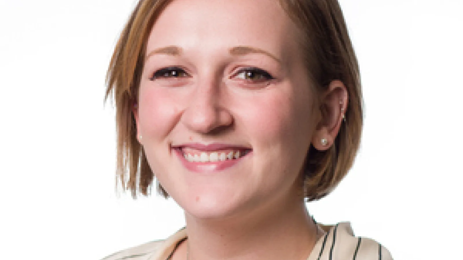 Image of white woman with blond hair, wearing a striped blouse smiling at the camera