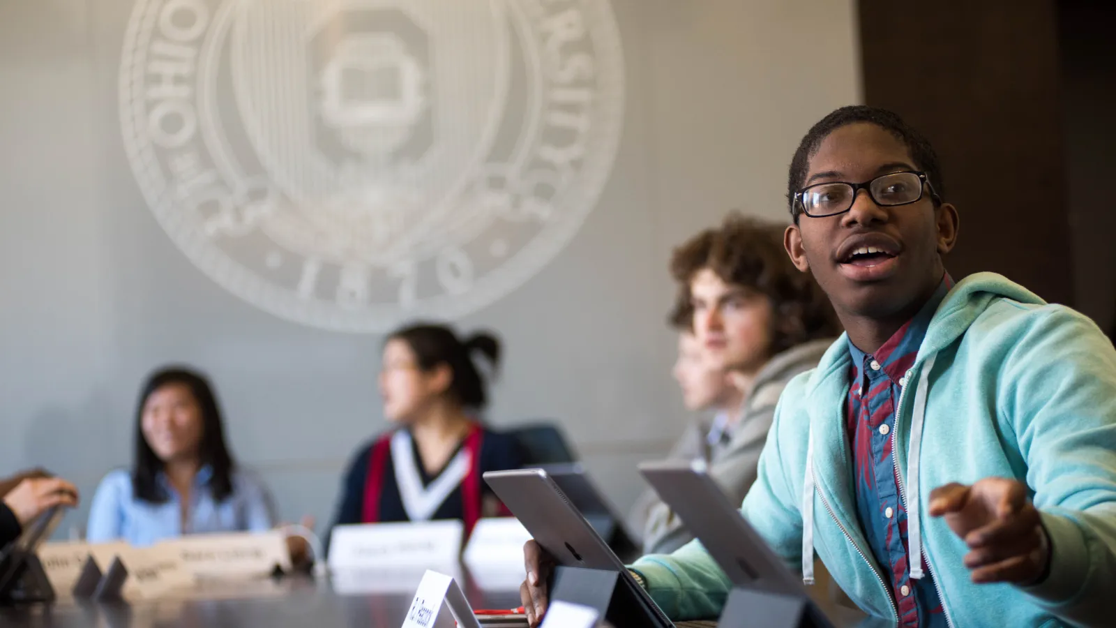 Young man answering question in interactive classroom