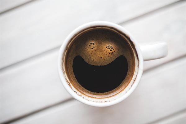 White mug with dark coffee in it
