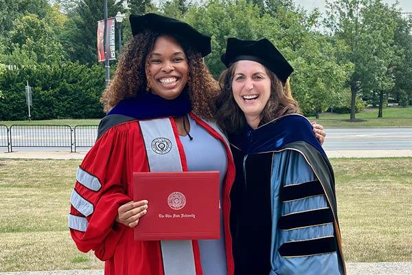 Chris Bijou and Cindy Colen wearing doctoral graduation regalia