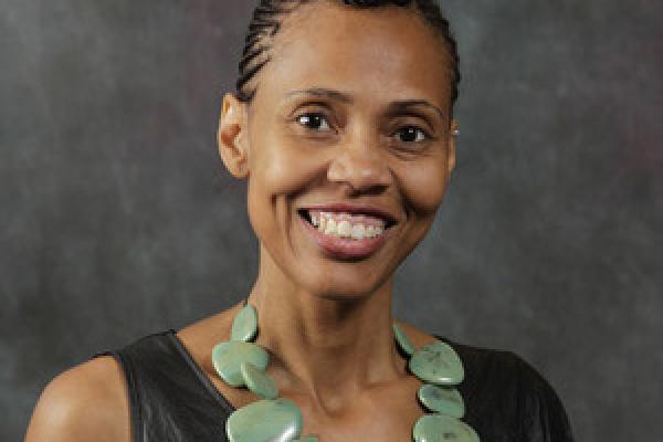 Female graduate student smiles at camera